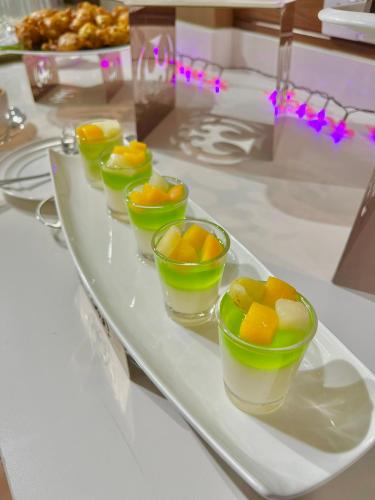 a tray with four bowls of fruit on a table at Langkawi Seaview Hotel in Kuah