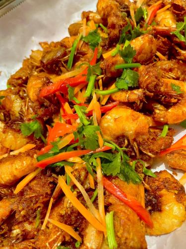 a plate of food with chicken and vegetables on it at Langkawi Seaview Hotel in Kuah