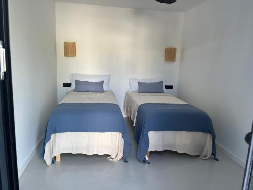 two beds sitting next to each other in a room at CasaNoa Luxury Villa Bed and Breakfast in Jávea
