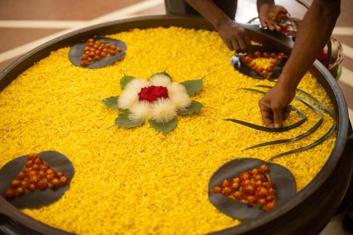 a person is preparing a cake with flowers on it at Trident Bhubaneswar in Bhubaneshwar