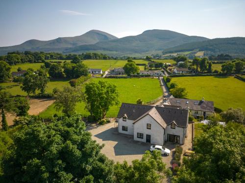 an aerial view of a house with mountains in the background at The Briers Country House in Newcastle