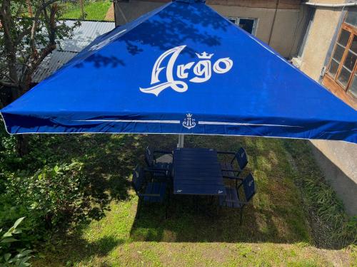 a blue umbrella sitting on the grass in a yard at View House in Mestia