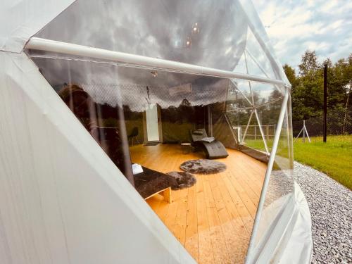 an inside view of a tent with a wooden floor at Poziom 713 in Trzebunia