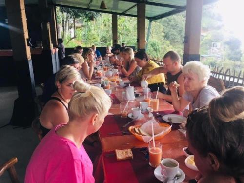 a group of people sitting at a long table at Ella Rock Heaven in Ella