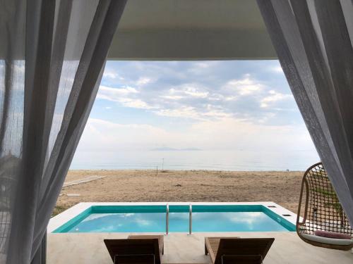 a view of a swimming pool from a beach house at Villa Bari Loft in Setiu