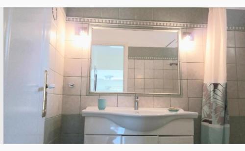 a bathroom with a sink and a mirror at Central, fully equipped, 2 bedrooms, great view, wifi in Philotium