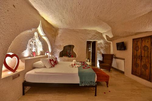 a bedroom with a bed in a stone room at Corner İn Cappadocia in Ortahisar