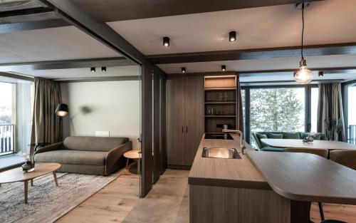 a kitchen and living room with a couch and a table at Surega - Idyllic Farmhouse in San Cassiano
