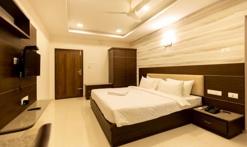 a bedroom with a large bed and a television at The Bee Hives , Nectar Nest in Coimbatore