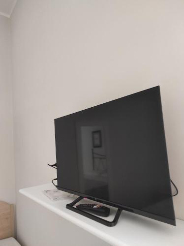 a flat screen tv sitting on a white shelf at Interno 12 - L'Aquila in LʼAquila