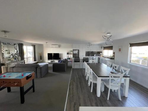 a living room with a table and a couch at Ocean Pearl by Ready Set Stay - BYO LINEN & TOWELS in Surf Beach