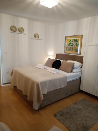 a bedroom with a large bed in a room at Zelena oaza in Baška Voda