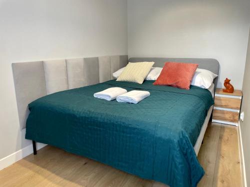 a bed with two pillows on it in a room at Przytulny apartament niedaleko dworca PKP in Radom