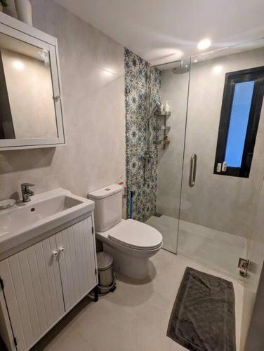 a bathroom with a toilet and a sink and a shower at 2 Bedroom Apartment in Naiyang - The Title Residences, Naiyang in Nai Yang Beach