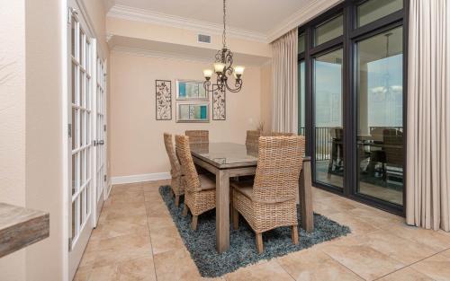 a dining room with a table and chairs at The Oasis 2214 formerly Phoenix West II 2214 in Orange Beach