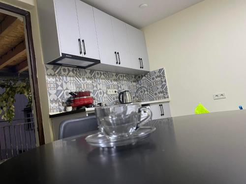 a glass cup sitting on a counter in a kitchen at Flats at Era Square in Batumi