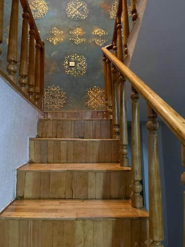 a set of stairs with a ceiling with gold designs at Flats at Era Square in Batumi
