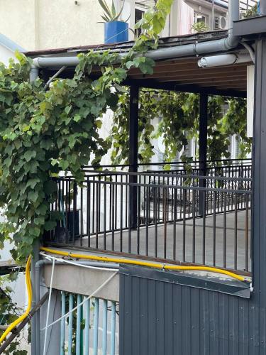 a black fence with a yellow hose on a building at Flats at Era Square in Batumi