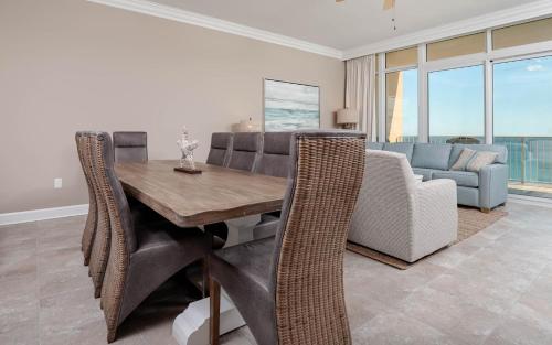 a dining room with a table and chairs and a couch at Phoenix Orange Beach II 1104 in Orange Beach