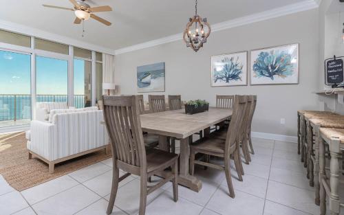 a dining room with a wooden table and chairs at Phoenix Orange Beach II 1702 condo in Orange Beach