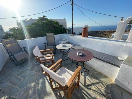 a patio with a table and chairs on a roof at Matsas Mansions in Chora Folegandros