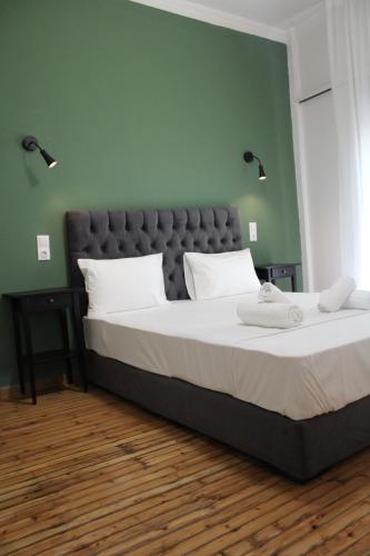 um quarto com uma cama grande e uma parede verde em Athens City Themis 16 em Atenas