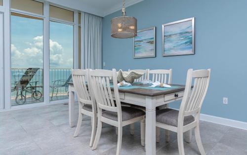 a dining room with a table and four chairs at Phoenix Orange Beach II 1103 condo in Orange Beach