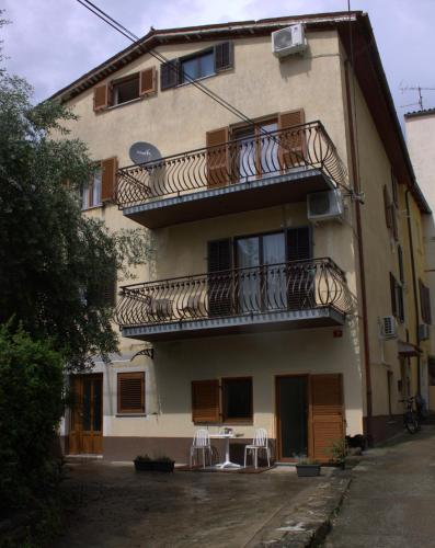 an apartment building with balconies and a table and chairs at Apartma SUZY in Koper