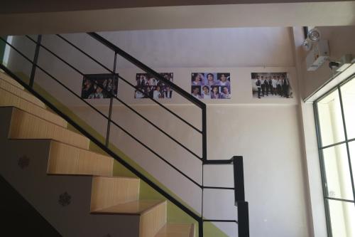 a staircase in a building with pictures on the wall at Yoo C Apartment in Dumaguete