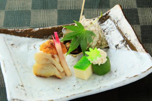 a plate of food on a table with food at Tensui Saryo in Hakone