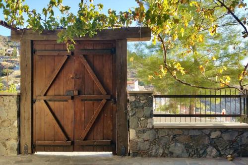 an old wooden door with a stone wall at Traditional House with Mountain View - Dierona Village in Dierona