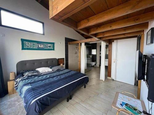 a bedroom with a large bed in a room at Villa Maloya in Saint-Leu