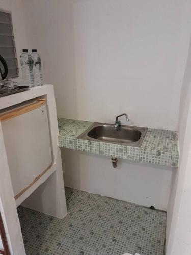 a kitchen with a sink and a counter top at Khaolak Banana Bungalow in Khao Lak