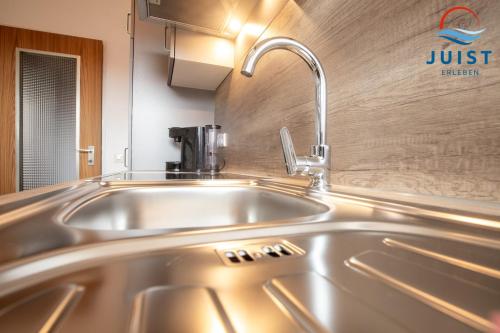 a stainless steel sink in a kitchen at Haus Hamburg 181 Wohnung 1 in Juist