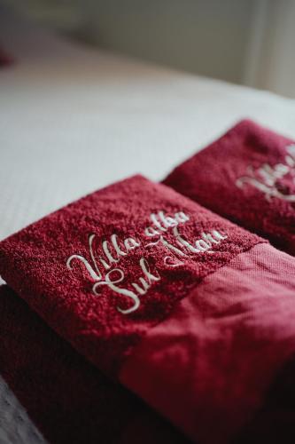 two red napkins with the words happy anniversary on them at Villa Alba Sul Mare in Budoni