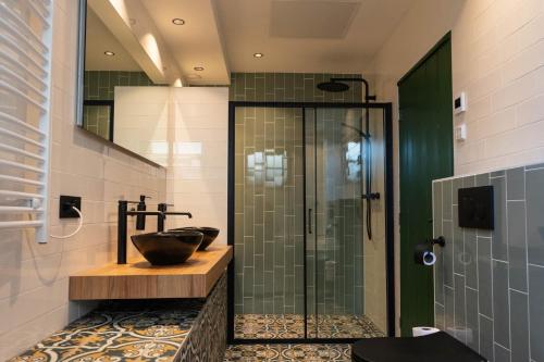 a bathroom with a glass shower and a sink at Luxe en ruim vakantiehuis voor 4 personen. in Nieuw-Lekkerland