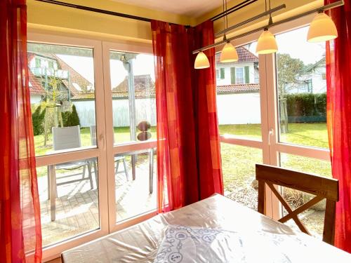 a bedroom with a bed and a large window at Dünenresidenz Karlshagen - Ferienwohnung am Gingsterweg in Ostseebad Karlshagen