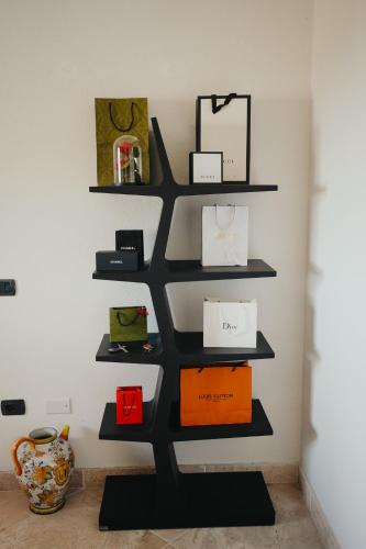 a shelf in the corner of a room with boxes at Villa Alba Sul Mare in Budoni
