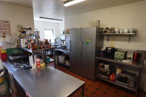 a kitchen with a counter and a large refrigerator at The Old Pier Guest Accommodation, bed only, no breakfast in Ballydavid