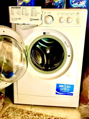a white washer and dryer sitting on a counter at Antiche Mura Apartments"Cielo di Puglia" -2 matrimoniali, cucina e terrazzo in Turi