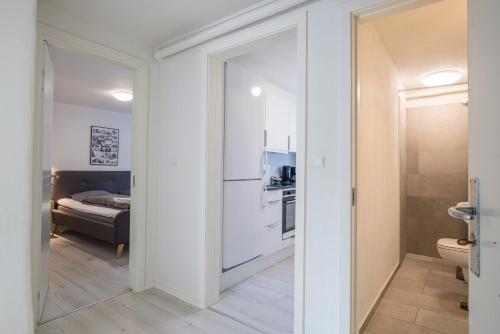 a small bathroom with a toilet and a kitchen at Newly renovated 1-Bed Apartment in Aalborg in Aalborg