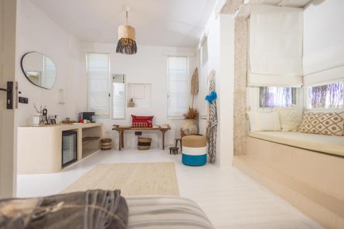 a white living room with a couch and a table at ZOE ALAÇATI in Alacati