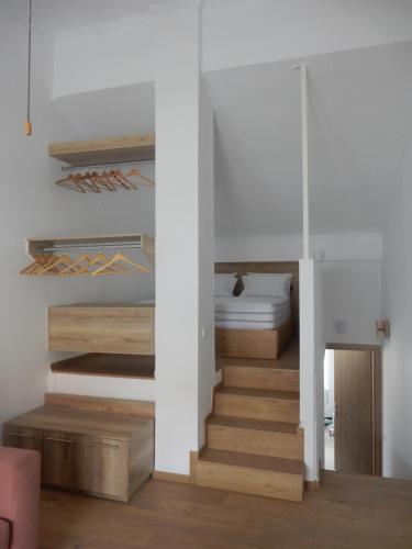 a room with a staircase leading up to a bedroom at Flamingo in Hanioti