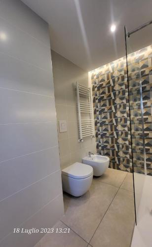 a white bathroom with a toilet and a sink at APARTMENT ANDROMEDA in Bari