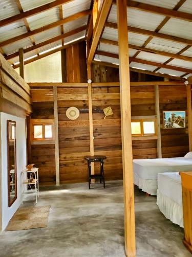 a room with two beds and a table in it at La posada de Mary in Montañita