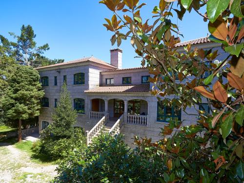 a large house with a chimney on top of it at Casa Río Samo in Garabanja