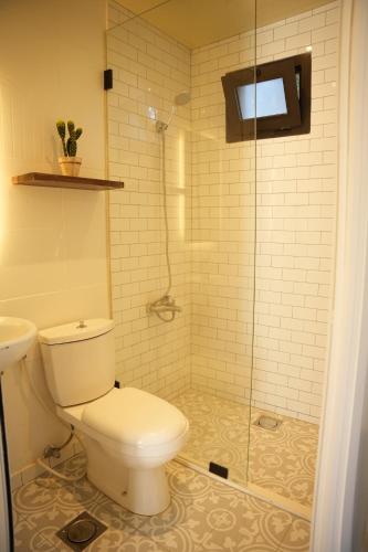 a bathroom with a toilet and a glass shower at The Ranch in Kfar Hazîr