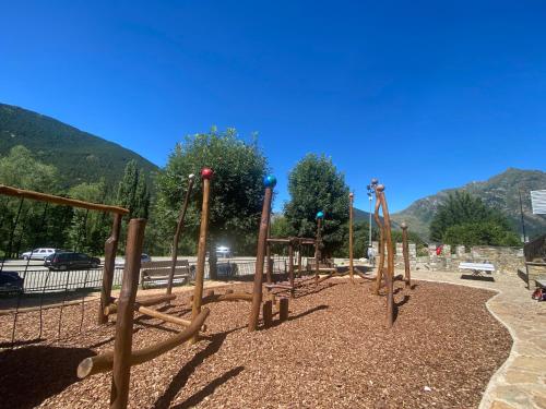 a playground with a bunch of wooden swings at Casa Valentí in Taull