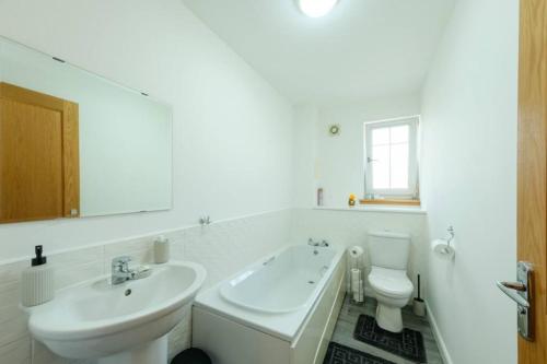 a white bathroom with a sink and a toilet at Super Prime East Coast Explorer - Inverkeithing in Inverkeithing