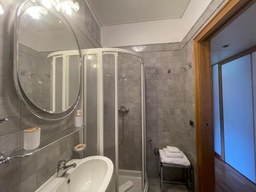 a bathroom with a shower and a sink and a mirror at Accomodo MIT37 Trivano Niguarda in Milan